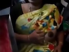 Indian shop keeper lady giving a show of her matured boobs for client